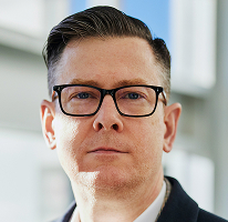 Headshot of Alexander Hughes, CEO and executive at a crypto trading company
